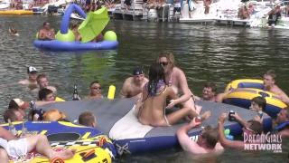 Hot Coed and MILF Play Naked on a Raft in Front of Huge Crowd 10