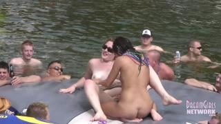 Hot Coed and MILF Play Naked on a Raft in Front of Huge Crowd 11