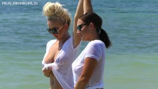 Two Hotties in Bikinis and Wet T-Shirts Playing at the Beach Flashing Boob 8