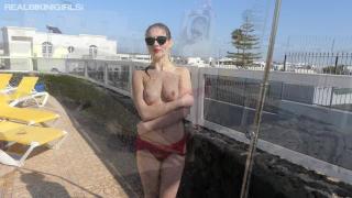 Young Redhead in Mesh Bikini goes Topless on the Roof 12