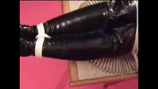 JADE TAPE GAGGED & BOUND TO COFFEE TABLE IN BLACK PVC CATSUIT & HIGH HEELED BOOTS 6